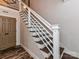 Close-up of a staircase with white railings, brown treads, and wood flooring at 4711 Truscott Rd, Charlotte, NC 28226
