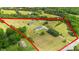 An aerial view outlining a property featuring a white home, a green barn, extensive lawns, and mature trees at 4855 Saluda Rd, Rock Hill, SC 29730
