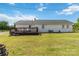 Expansive backyard view featuring a wooden deck and well-maintained lawn at 4855 Saluda Rd, Rock Hill, SC 29730