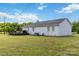 Exterior view of the backyard, showcasing the well-kept lawn and the house's exterior at 4855 Saluda Rd, Rock Hill, SC 29730