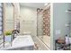 This remodeled bathroom features an updated shower-tub combo with gray and tan accents at 4855 Saluda Rd, Rock Hill, SC 29730