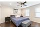 Bedroom features a bed with navy bedding, a ceiling fan, and two windows at 4855 Saluda Rd, Rock Hill, SC 29730