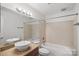Bathroom features double vanity, granite countertop, tub, and tiled shower at 513 N Graham St # 1B, Charlotte, NC 28202