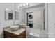 Bathroom features double vanity, granite countertop, and stacked washer and dryer at 513 N Graham St # 1B, Charlotte, NC 28202