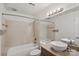 Bathroom features tile flooring, large mirror, tub, and tiled shower at 513 N Graham St # 1B, Charlotte, NC 28202
