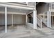 Attached covered carport and stairs leading to a second floor unit with neutral siding at 513 N Graham St # 1B, Charlotte, NC 28202