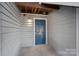 Inviting blue front door with stylish light fixture on a gray siding exterior with visible address number at 513 N Graham St # 1B, Charlotte, NC 28202