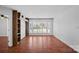 Spacious living room with hardwood floors, large windows, and custom shelving at 513 N Graham St # 1B, Charlotte, NC 28202