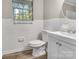 Cozy bathroom featuring a single sink vanity and white tile walls at 5221 Wales St, Charlotte, NC 28269