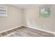 A view of the bedroom showing two windows and hardwood floors at 5221 Wales St, Charlotte, NC 28269