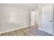 Neutral bedroom with light walls, new flooring, and several open doorways at 5221 Wales St, Charlotte, NC 28269
