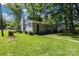 An eye-level view of the house, with abundant foliage at 5221 Wales St, Charlotte, NC 28269