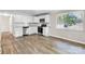 Kitchen with stainless steel appliances, white cabinets, granite countertops, and new flooring at 5221 Wales St, Charlotte, NC 28269