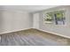 Spacious living room featuring neutral walls, new flooring, and a bright window at 5221 Wales St, Charlotte, NC 28269