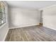 Bright, open living room with neutral walls, new flooring, and large windows letting in natural light at 5221 Wales St, Charlotte, NC 28269