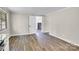 Neutral open space with a view into another room, featuring new flooring and freshly painted walls at 5221 Wales St, Charlotte, NC 28269