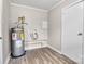 A view of the utility room with water heater and hookups for washer and dryer at 5221 Wales St, Charlotte, NC 28269