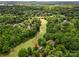 Aerial view of a home situated on a golf course and surrounded by mature trees at 54 Honeysuckle Woods, Clover, SC 29710