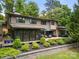 Beautiful backyard with a large deck, outdoor seating, manicured landscaping, and a retaining wall at 54 Honeysuckle Woods, Clover, SC 29710