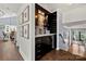 Hallway bar area with black cabinets, wine rack and granite countertops near staircase at 54 Honeysuckle Woods, Clover, SC 29710