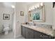 Elegant bathroom featuring a granite vanity top, decorative mirror, and a neutral-toned shower with curtain at 54 Honeysuckle Woods, Clover, SC 29710