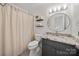 Cozy bathroom featuring a granite vanity top, decorative mirror, and a neutral-toned shower with curtain at 54 Honeysuckle Woods, Clover, SC 29710
