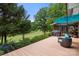 Spacious deck with outdoor seating and umbrella overlooking a lush golf course and mature trees at 54 Honeysuckle Woods, Clover, SC 29710