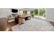 Bright living room features a modern rug, comfortable seating, and sliding glass door to deck at 54 Honeysuckle Woods, Clover, SC 29710