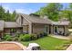 Charming single-story home with a well-manicured lawn, patio space, lush landscaping, and grey exterior at 54 Honeysuckle Woods, Clover, SC 29710