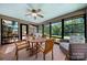 Bright sunroom features large windows offering stunning views of the outdoors, with seating and dining area at 54 Honeysuckle Woods, Clover, SC 29710
