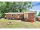 The backyard features a cozy firepit and lush green lawn, perfect for gatherings at 6517 Paleface Pl, Charlotte, NC 28214