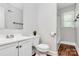This bathroom features a new toilet, vanity and mirror with fresh paint at 6517 Paleface Pl, Charlotte, NC 28214