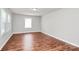 An empty bedroom with pristine walls, wood floors, and a bright window, showcasing the room's potential at 6517 Paleface Pl, Charlotte, NC 28214