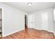 Bedroom with fresh paint, wood floors, closets and bright windows with coverings at 6517 Paleface Pl, Charlotte, NC 28214