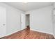 The bedroom features neutral-colored walls and beautiful wood-look laminate flooring at 6517 Paleface Pl, Charlotte, NC 28214