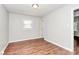 This bedroom features hardwood floors and neutral walls, complemented by a bright window at 6517 Paleface Pl, Charlotte, NC 28214