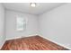 Empty bedroom features neutral paint, wood flooring, and natural light, ready for personalization at 6517 Paleface Pl, Charlotte, NC 28214