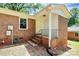 Brick home with tidy landscaping and convenient backyard access at 6517 Paleface Pl, Charlotte, NC 28214