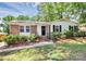 Inviting brick home with tidy landscaping, black shutters, and a welcoming entrance at 6517 Paleface Pl, Charlotte, NC 28214
