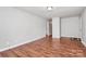 A freshly painted living room with new wood flooring and views into other areas of the house at 6517 Paleface Pl, Charlotte, NC 28214