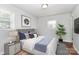 Cozy bedroom with stylish décor, a comfortable bed with coordinated linens, and plenty of natural light at 6517 Paleface Pl, Charlotte, NC 28214