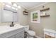 Bathroom featuring a toilet, sink with vanity, and window bringing in plenty of natural light at 702 S Government St, Lincolnton, NC 28092