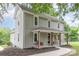 Charming two-story home boasts a welcoming front porch, landscaped yard, and classic architectural details at 702 S Government St, Lincolnton, NC 28092