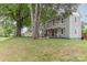 Traditional two-story home with covered front porch, mature trees, and a well-maintained lawn at 702 S Government St, Lincolnton, NC 28092