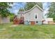 Back exterior featuring a wooden deck and access to a large yard, fenced for privacy and security at 702 S Government St, Lincolnton, NC 28092