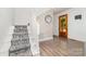 Bright foyer with hardwood flooring, staircase with patterned runner, and decorative mirror at 702 S Government St, Lincolnton, NC 28092