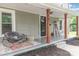 Inviting front porch with rocking chair, plants, and decorative elements, creating a cozy outdoor space at 702 S Government St, Lincolnton, NC 28092