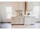 Stylish kitchen featuring white cabinetry, stainless steel appliances, and bright natural light at 702 S Government St, Lincolnton, NC 28092