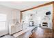 Bright kitchen with white cabinetry, stainless steel appliances, and a spacious dining area at 702 S Government St, Lincolnton, NC 28092