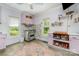 Well-lit kitchen boasts stainless steel appliances, pastel-colored cabinets, a large window, and wood-look floors at 702 S Government St, Lincolnton, NC 28092